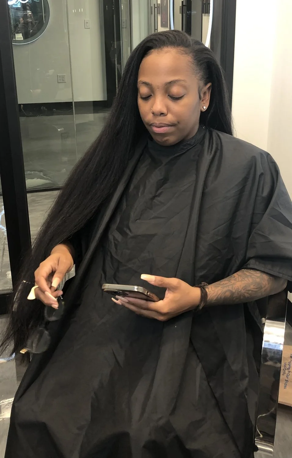 Long straight hair extensions with a sleek polished finish in Arlington, Texas.